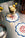 A martini with an olive sits on Octaevo Amalfi Coasters beside olives, a canned drink, and another coaster.