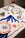 A table set with ocean-inspired plates, embroidered decor, and Octaevo’s Amalfi Placemat (Set of 2) on a white cloth.