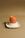 The OCTAEVO Soft-Boiled Egg Candle sits on a white dish, perfect for adding a breakfast-themed touch to your decor.