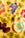 OCTAEVO Fruit Serving Plate: Colorful embossed fruit/leaf Art Nouveau pattern on yellow, inspired by French majolica.