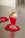 A pink float with ice cream and cherry sits on an Octaevo Red Anthurium Coaster, spoon beside it.