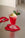 A pink float with vanilla ice cream and mint sits on an Octaevo Red Anthurium coaster next to a silver spoon.