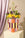 Octaevo Patio Mini Paper Vase with yellow and purple blooms on pedestal, set against Mediterranean decor.