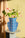 The OCTAEVO Icarus Paper Vase with assorted flowers sits on a small table, bathed in sunlight.