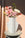The OCTAEVO Lido Paper Vase with a grid design displays pink and white flowers on a sunlit round table.