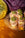 Six OCTAEVO Pistachio Cruffin Ornaments add festive charm to a gold plate near a yellow disco ball and purple cloth.