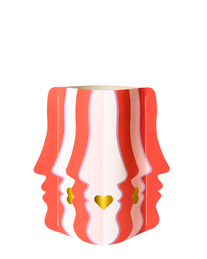 The OCTAEVO Beso Mini Paper Vase features red and white face profiles with gold hearts on a plain white background.