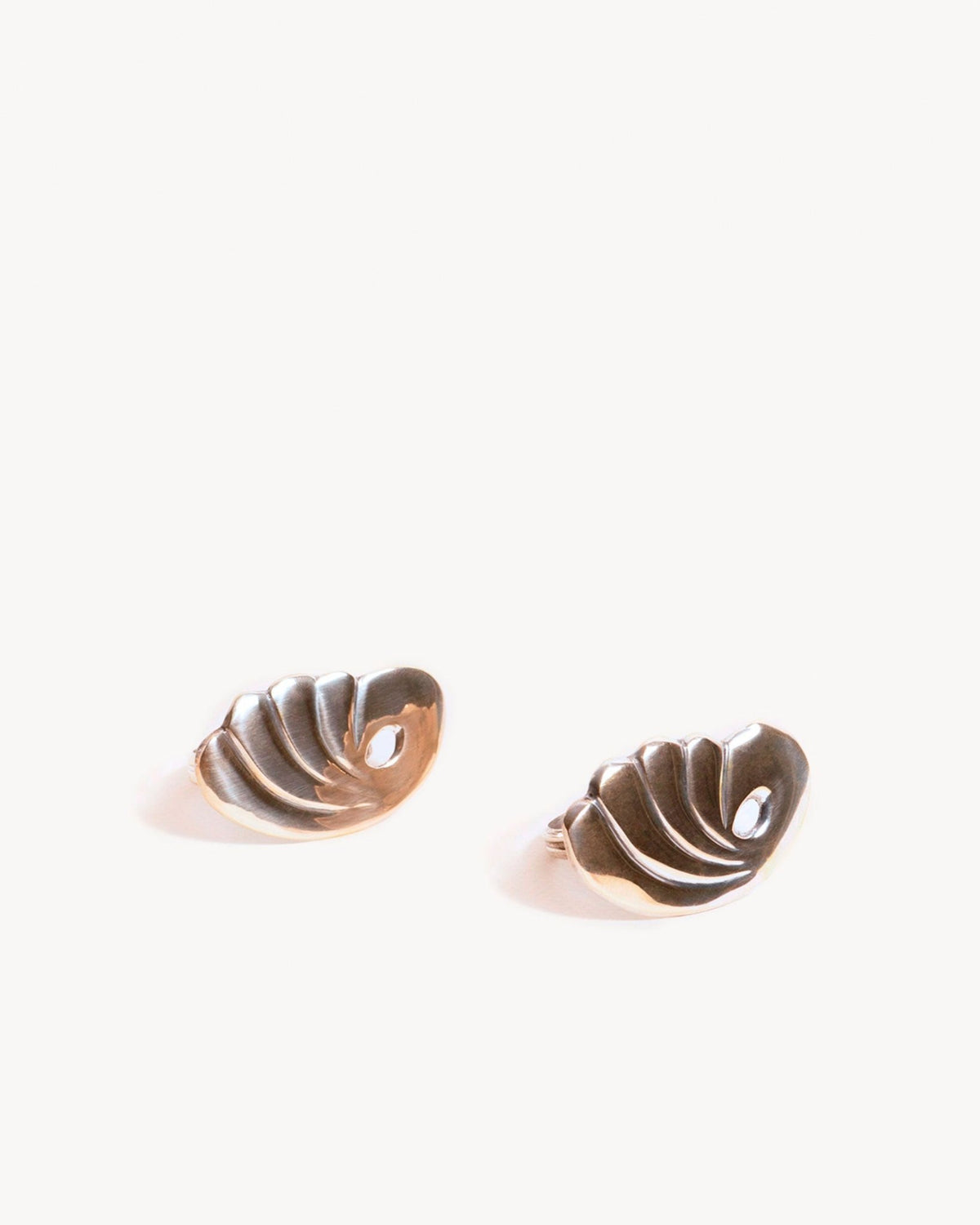 A set of two small, shiny silver bird napkin rings by Octaevo—perfect as collectible gifts.