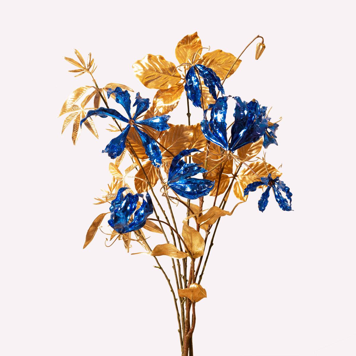 The Octaevo Blue Gold Leaf Bouquet is a striking Christmas centerpiece with vibrant blue and gold accents.