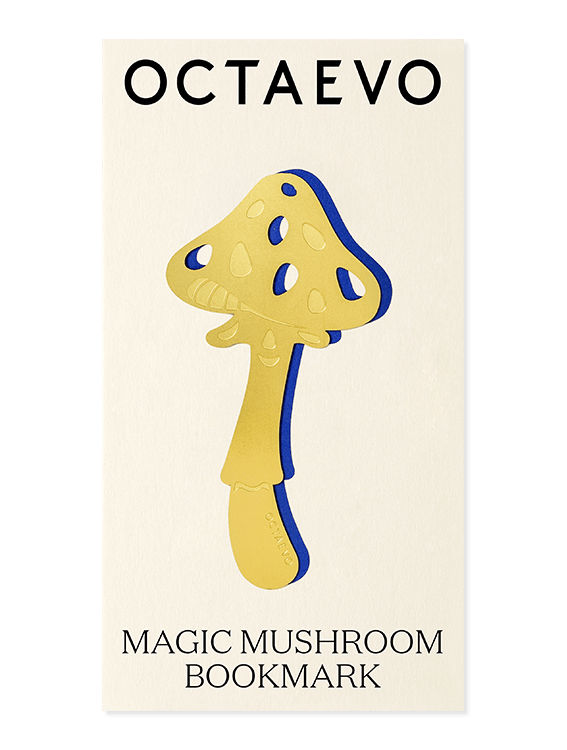 A gold Magic Mushroom bookmark by OCTAEVO with blue edges, presented on a cream card.