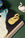 The Octaevo Bookmark Swan symbolizes eternal love, displayed on an open book near a ceramic swan on green.