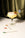 A yellow cocktail in a coupe glass is garnished with Octaevo Candy Crush Cocktail Picks and a cherry on white.