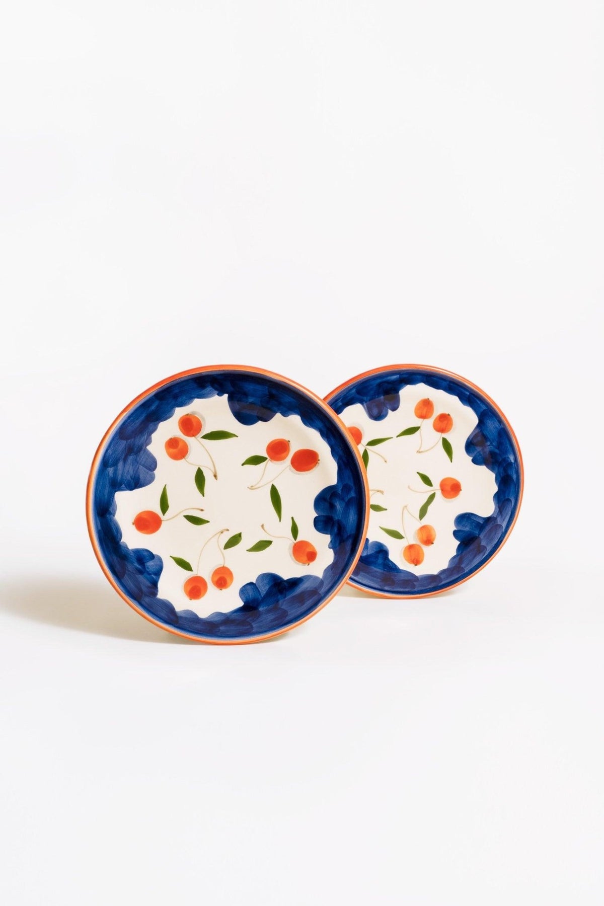 Two OCTAEVO Ceramic Plates Cherry (Set of 2) overlap on a white background.