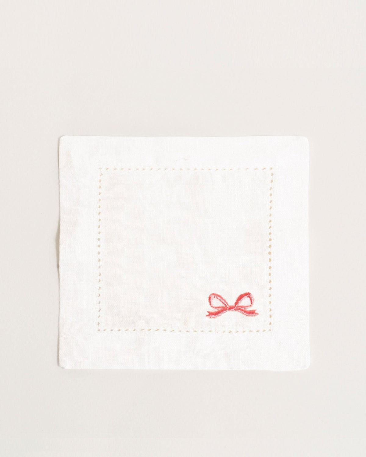 Octaevo Cocktail Napkin Bow, Set of 2—white embroidered linen with pink bow; reusable and eco-friendly.