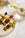 Octaevo Dolce Vita Cocktail Picks (Set of 4) displayed with olives, anchovies, peppers, and a cherry tomato.