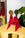 The Fire Paper Sculpture by Octaevo: a red and gold recycled cardboard decor piece on a yellow table with plant and mirror.