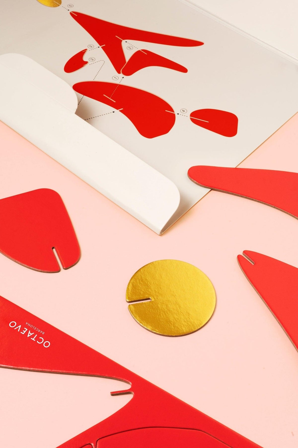 The Fire Paper Sculpture by Octaevo features red and gold cutouts—artistic home decor made from recycled cardboard.