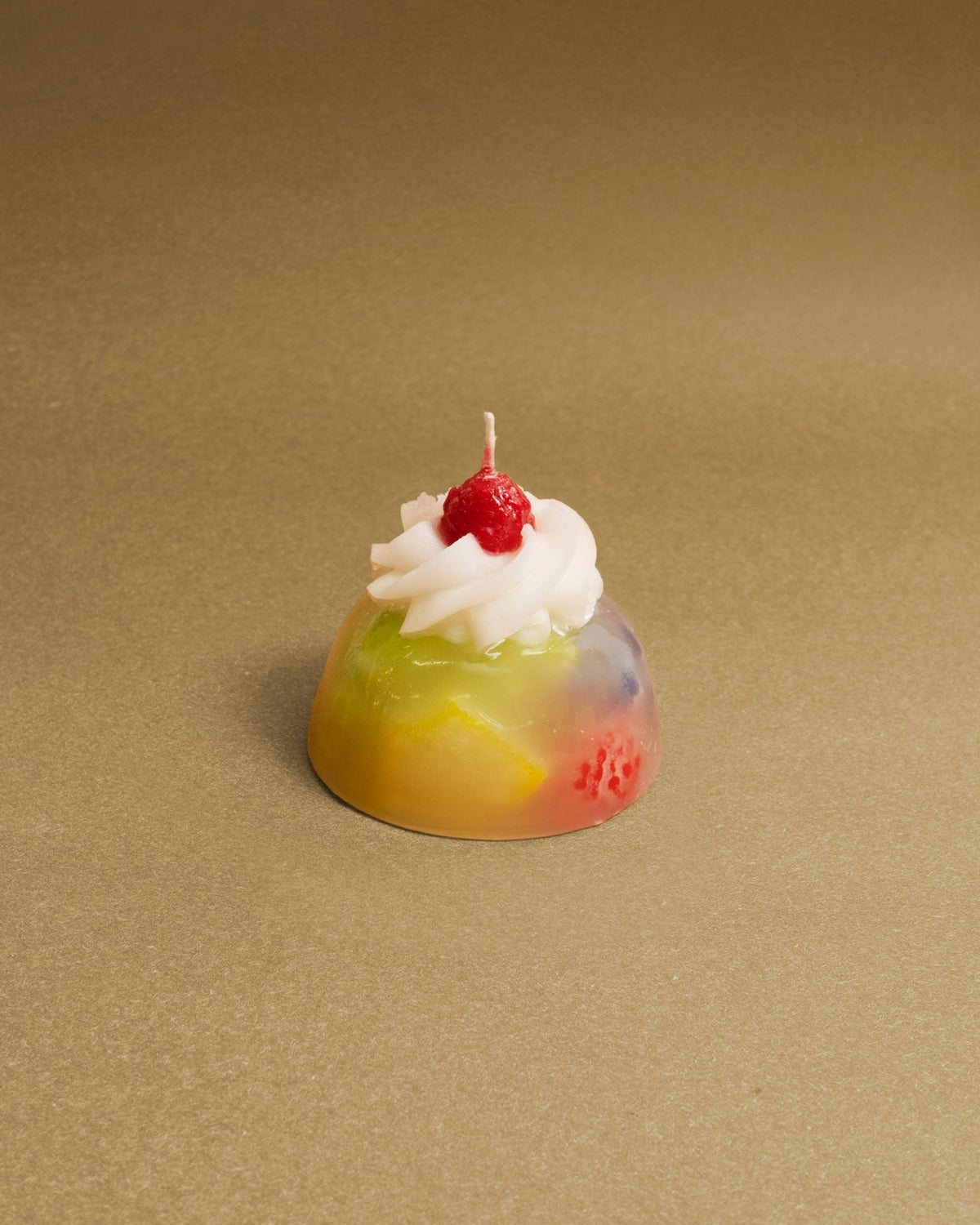 Octaevos Fruit Jelly Dessert Candle features a colorful dome, white swirls, and a red cherry—ideal tabletop decor.