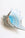 A close-up of the OCTAEVO Glass Conch Shell Sculpture with blue and brown swirls on a white background.
