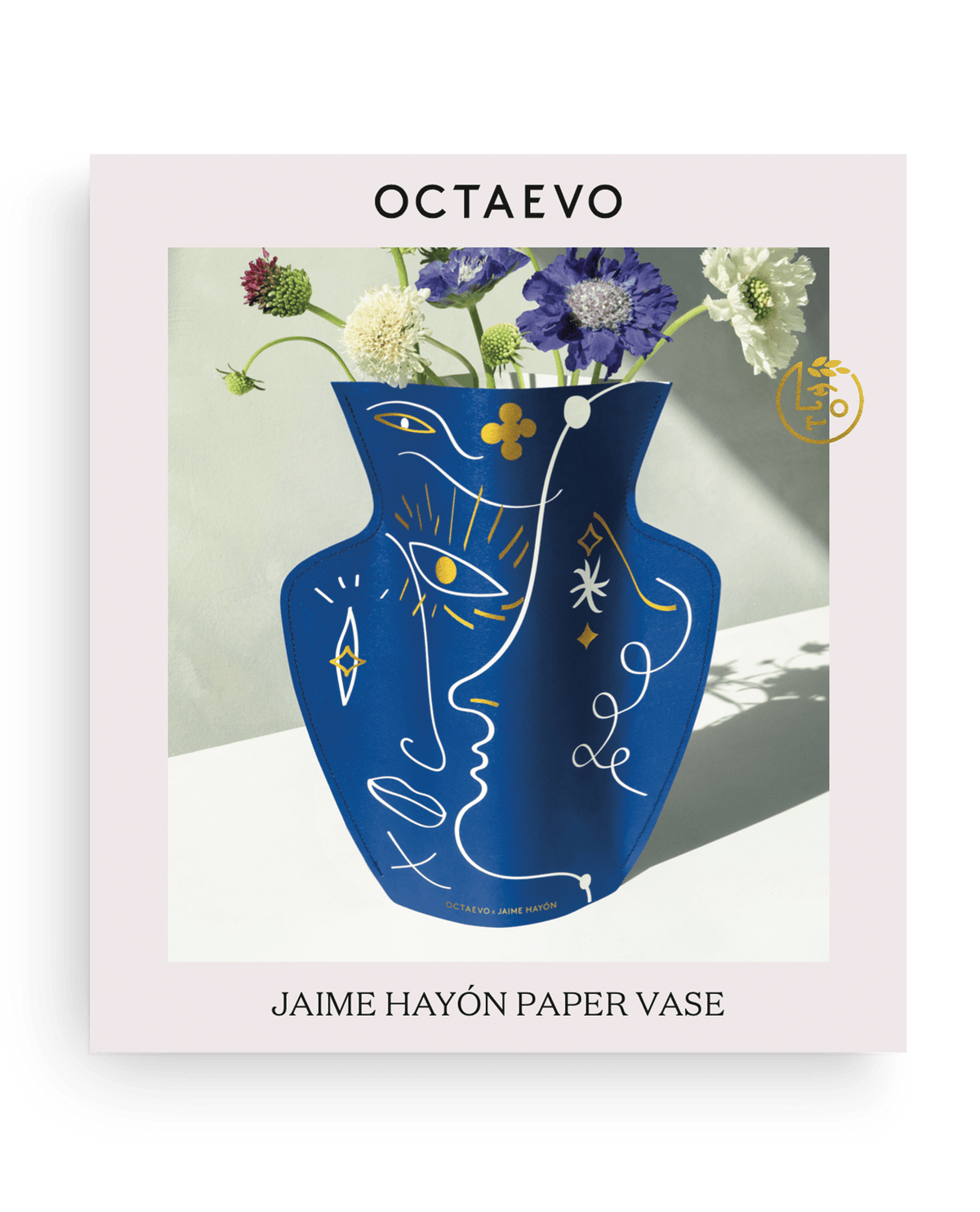 OCTAEVO Jaime Hayon Paper Vase—Vasage Blue: abstract blue vase with assorted flowers, in stylish white packaging.