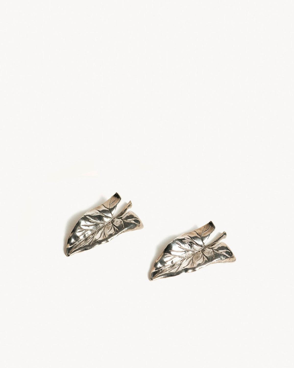OCTAEVO Leaf Knife Rests (Set of 2): Silver leaf-shaped rests, elegant as table decor or vintage earring display.