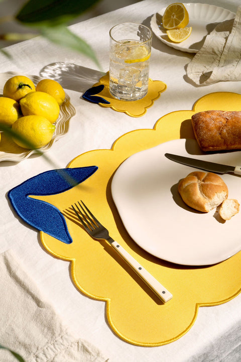 OCTAEVO Lemon Placemats (Set of 2)—yellow linen-cotton, blue accents—add Mediterranean flair to your sunlit table.