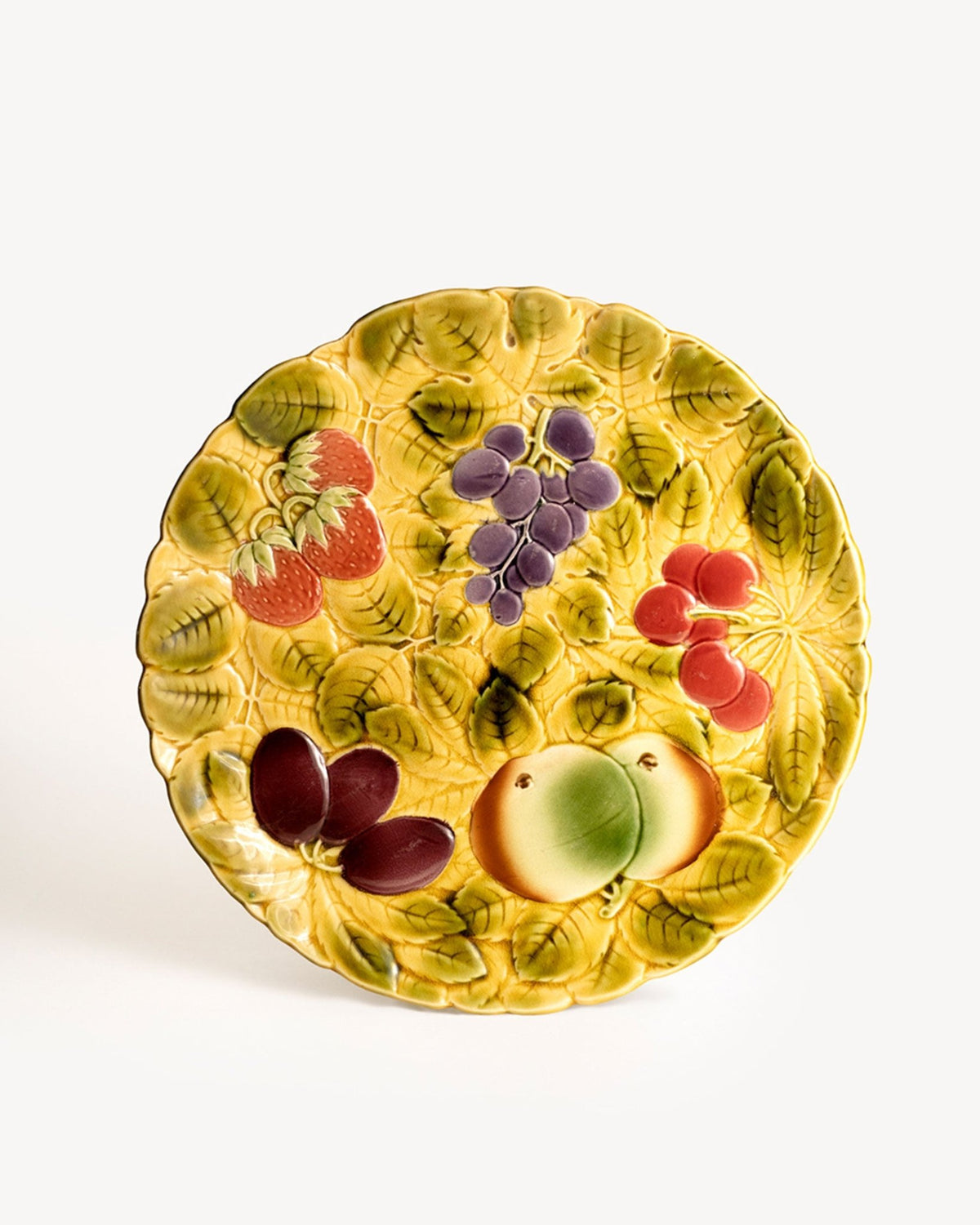 OCTAEVO Majolica Serving Platter featuring a yellow leafy background and colorful fruits in Art Nouveau style.