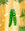 Octaevo Merry Greens Baubles (Pack of 3) hang from a Christmas tree branch against a gold bokeh background.
