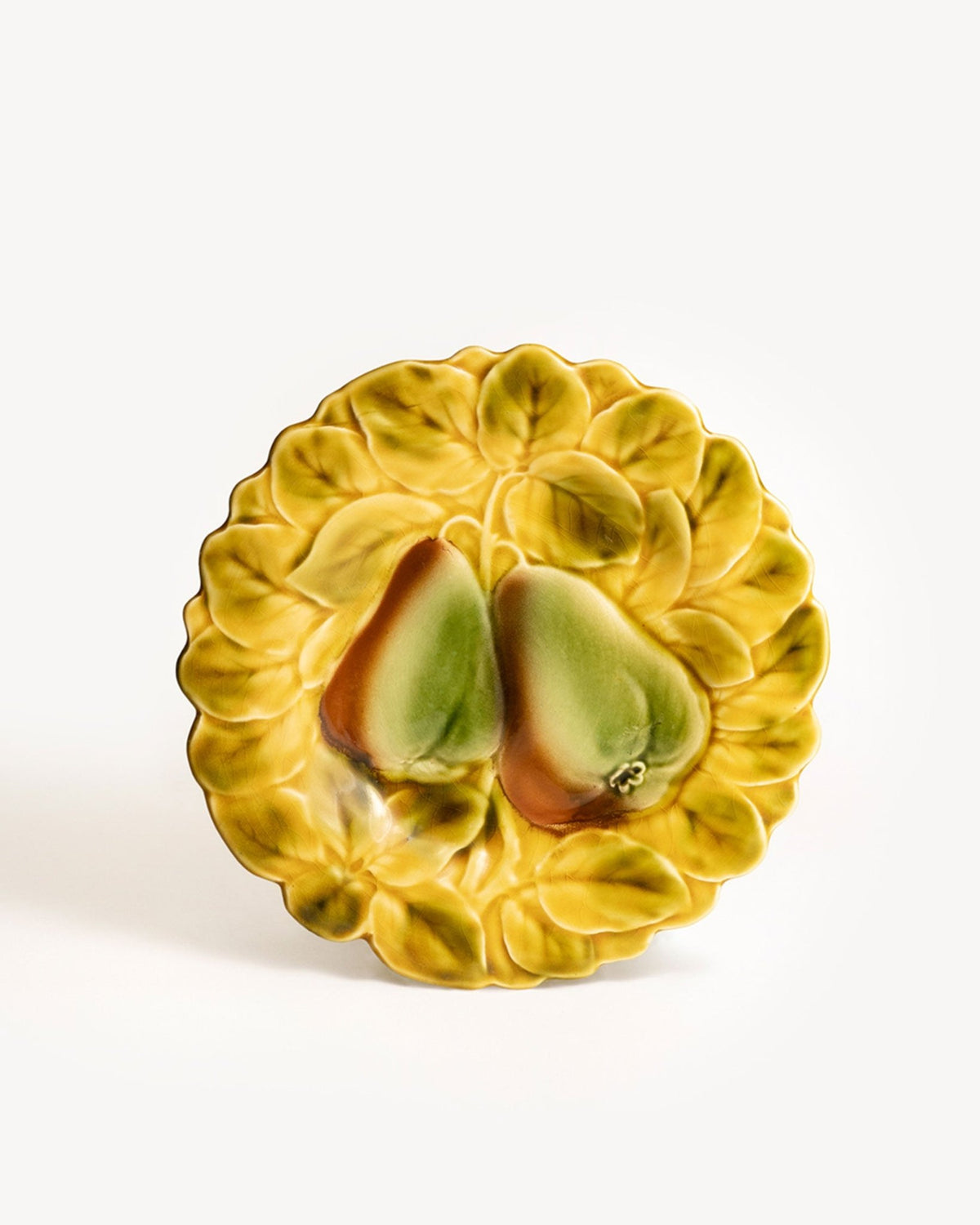 Pear Majolica Plate by OCTAEVO with raised leaf and two pears on white background.