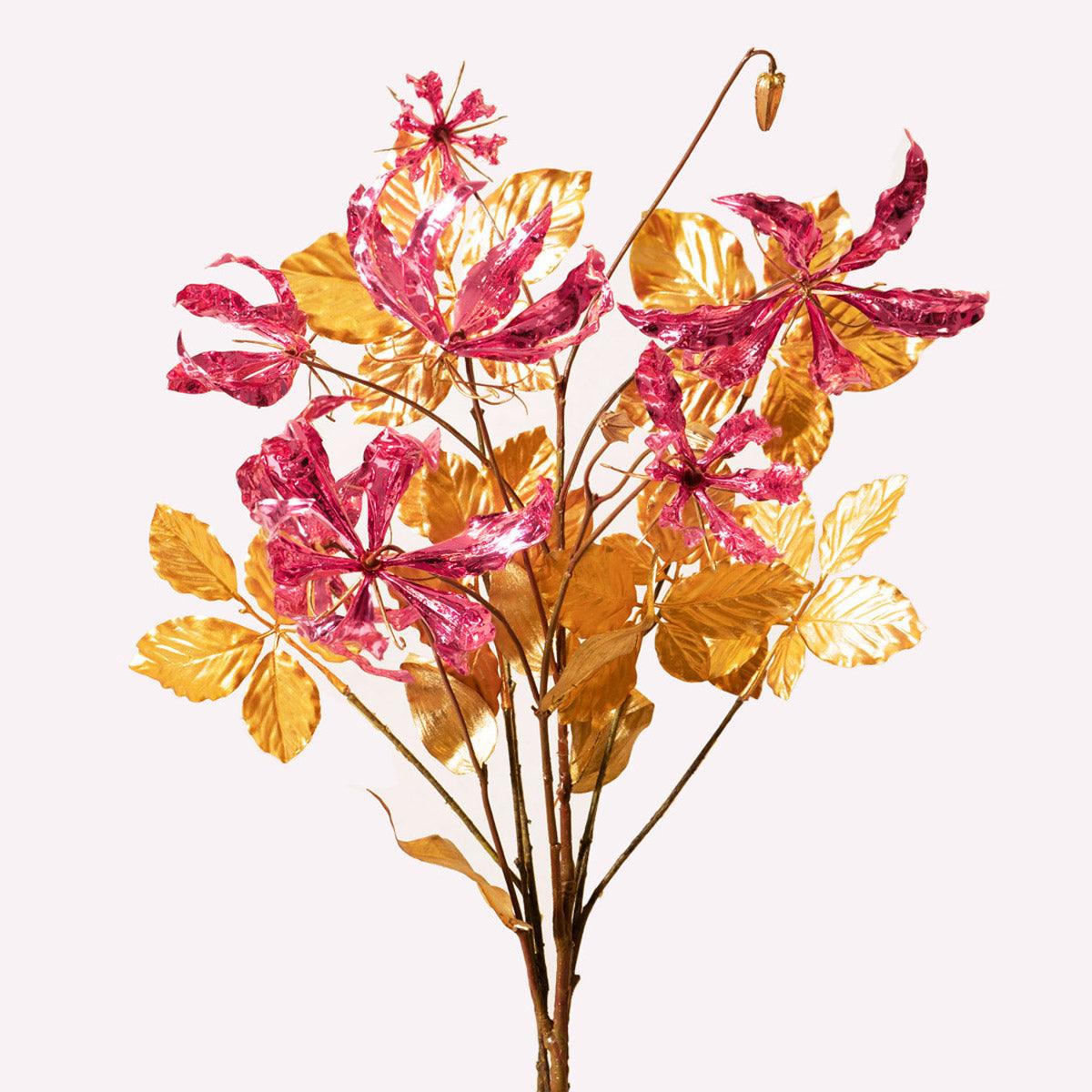The Octaevo Pink Gold Leaf Bouquet features Gloriosa flowers and gold accents, perfect as a Christmas centerpiece.