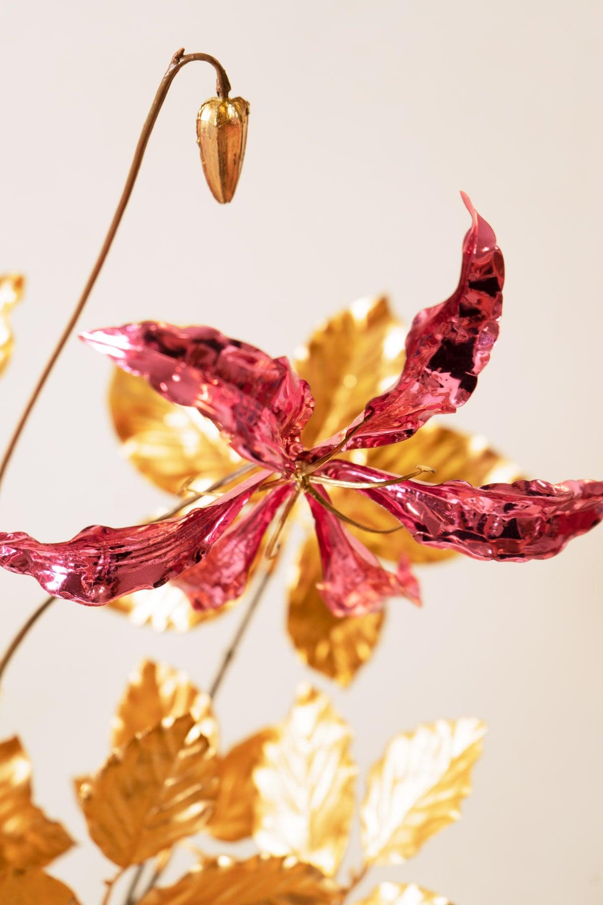 The Octaevo Pink Gold Leaf Bouquet features metallic pink flowers with gold leaves, ideal for a Christmas centerpiece.