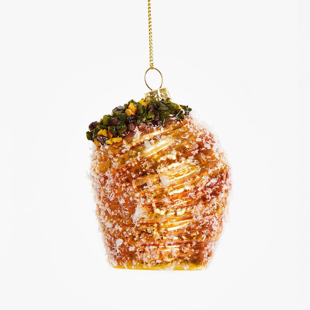 OCTAEVO’s Pistachio Cruffin Ornament adds festive charm with its shiny glass finish and green, brown, yellow accents.