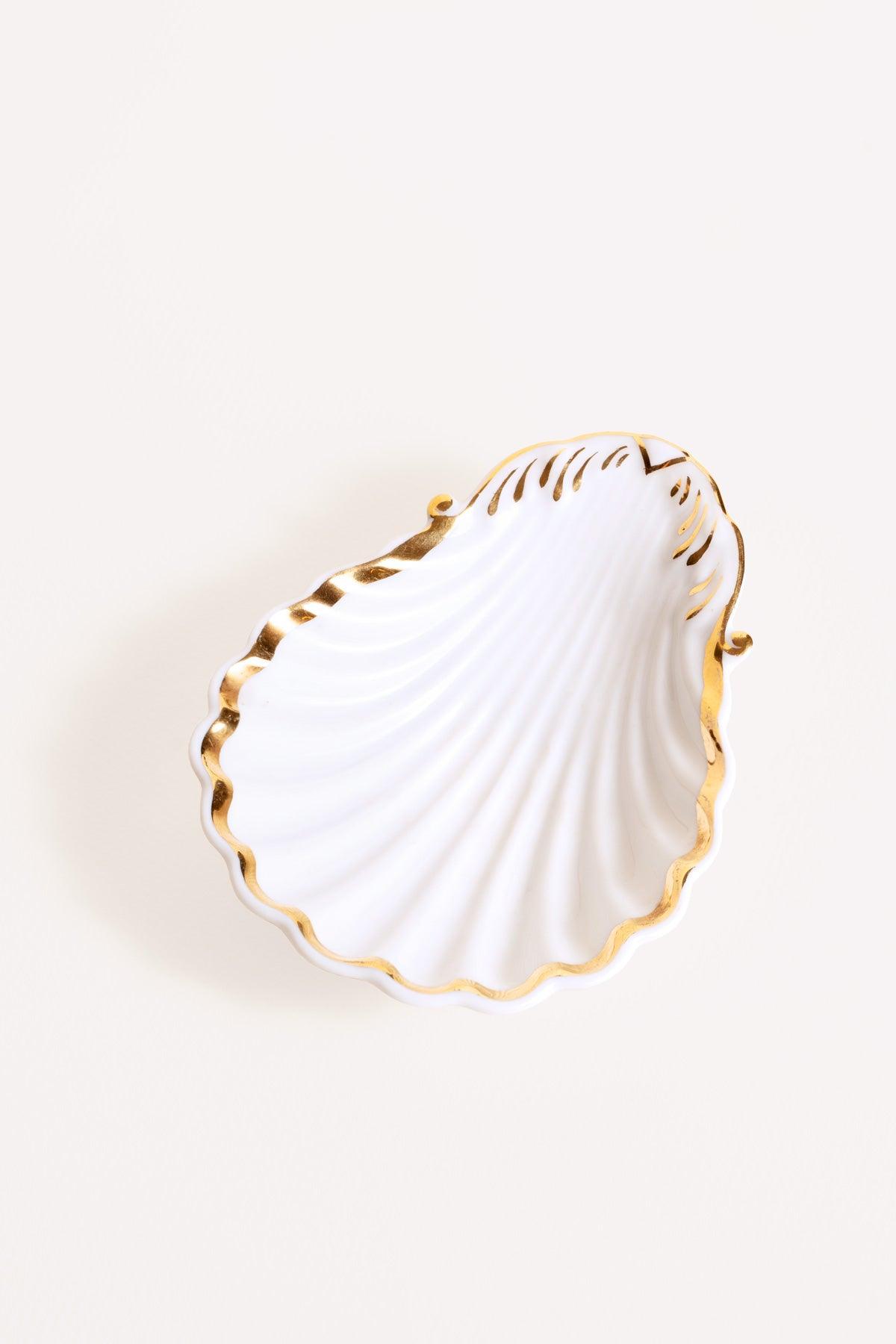 The Octaevo Shell Bowl features hand-painted gold edges for a touch of coastal elegance in any space.