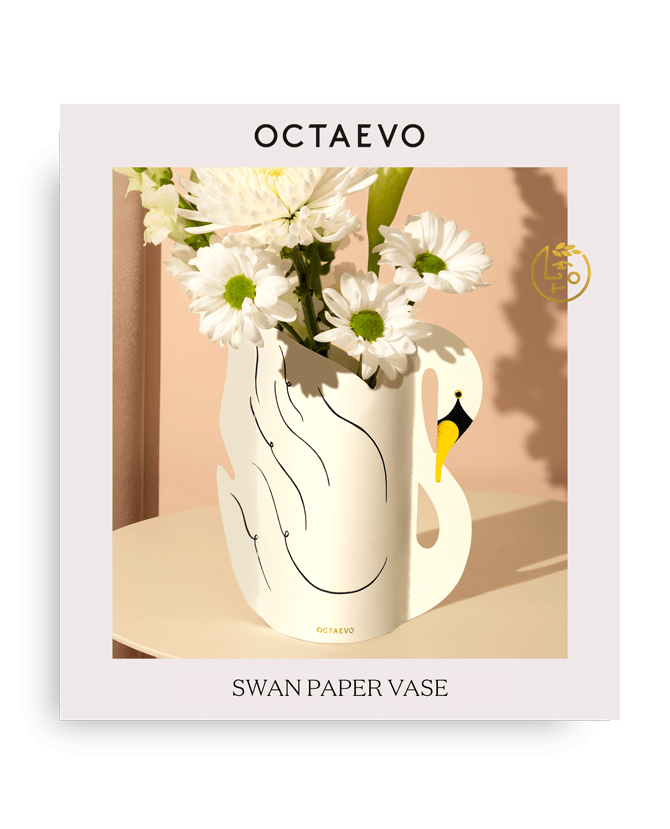 Octaevo Schwan-Mini-Papiervase, wasserabweisend, in Schwanenform mit Gänseblümchen, in Markenverpackung, vor pfirsichfarbenem Hintergrund.