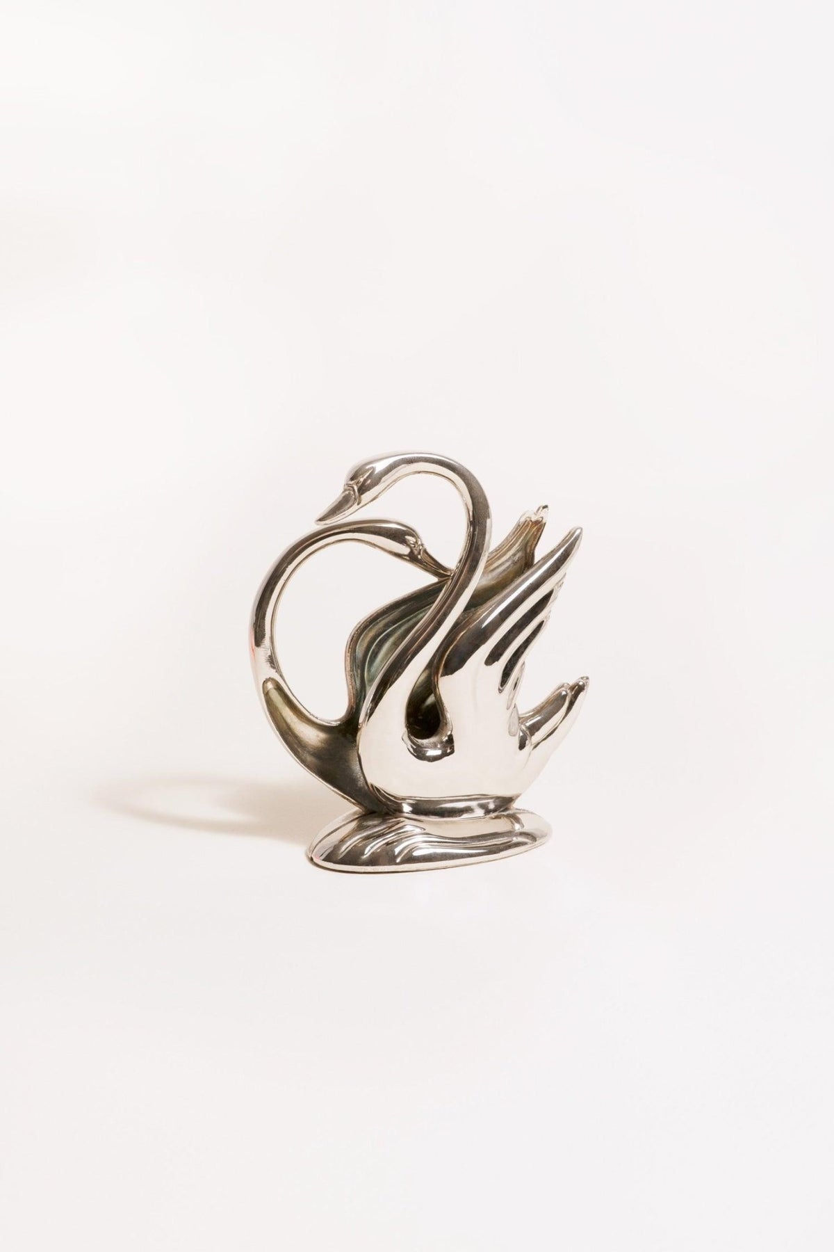 The Octaevo Swan Napkin Holder, silver-plated and shiny, is displayed against a plain white background.