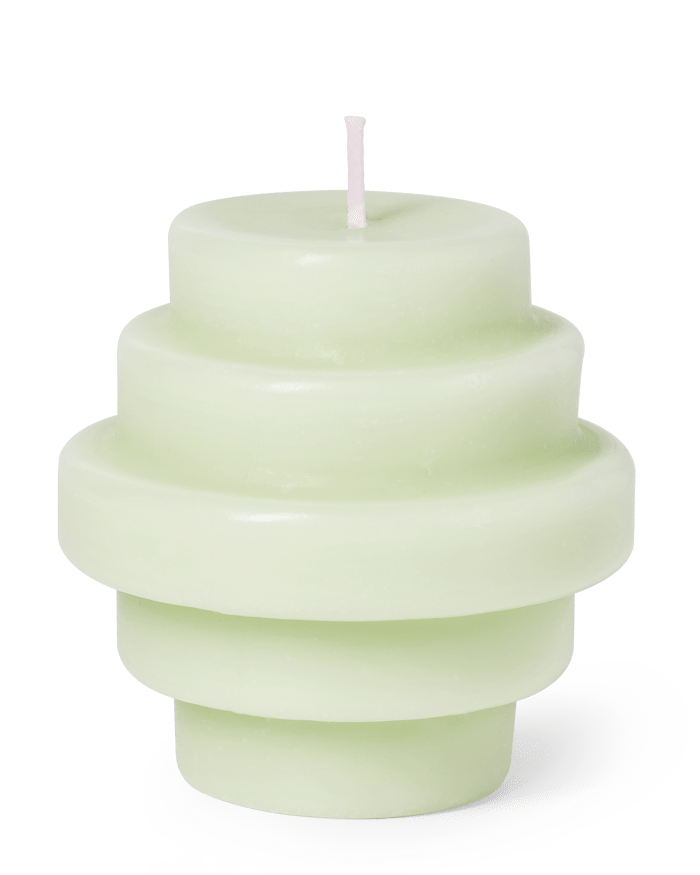 The Templo Candle by OCTAEVO is a light green, hand-poured wax candle with a stacked ring geometric design.