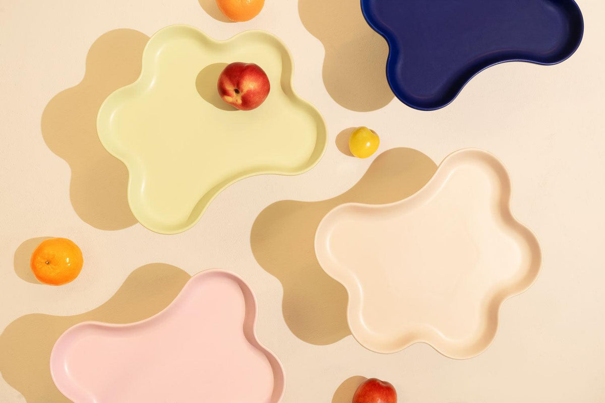 The Octaevo Templo High Tray in pastel tones makes a modern centerpiece when filled with peaches and oranges.