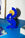 The Water Paper Sculpture by Octaevo, in blue and gold, adds modern art style to your home decor on a blue desk.