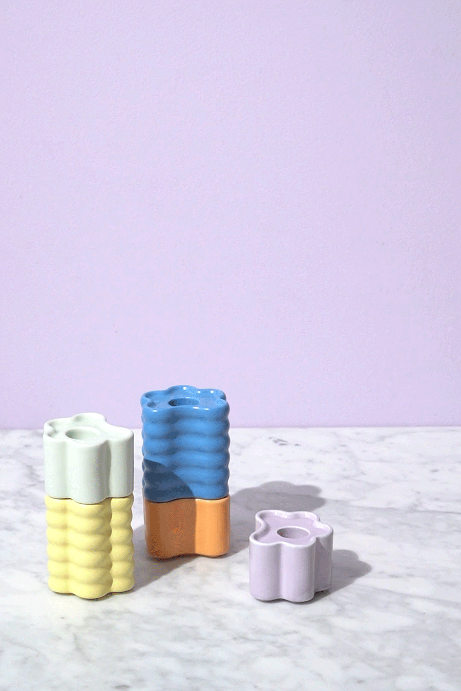 The Flora Candle Holder — Small by OCTAEVO adds a sculptural accent with its wavy, hand-glazed ceramic design.