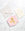 Pink card with gold abstract face beside an OCTAEVO Apolino Mini Paper Vase and open envelope on marble.