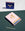 OCTAEVO Apollo Matches: a pink and blue matchbox with gold foil, blue-tipped matches on a green textured surface.