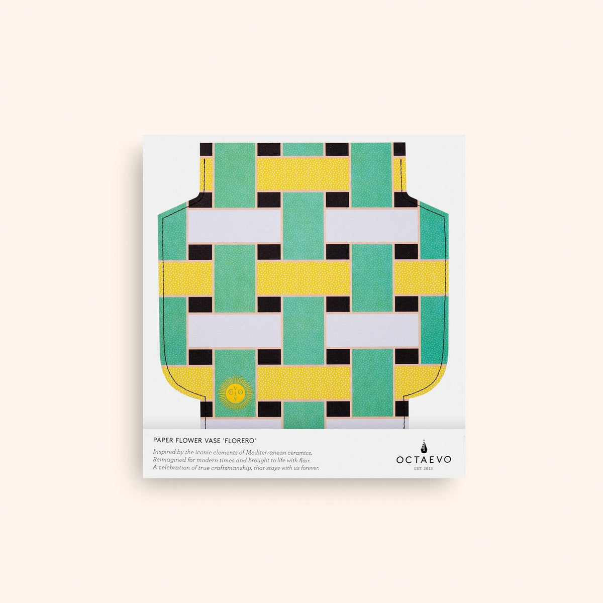 The Artesania Paper Vase by OCTAEVO features a green, yellow, and black geometric design on waterproof paper.