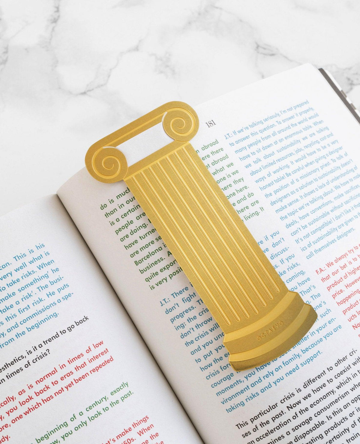 OCTAEVO Bookmark Artemis in brass, inspired by the Greek Temple, rests on a book. 