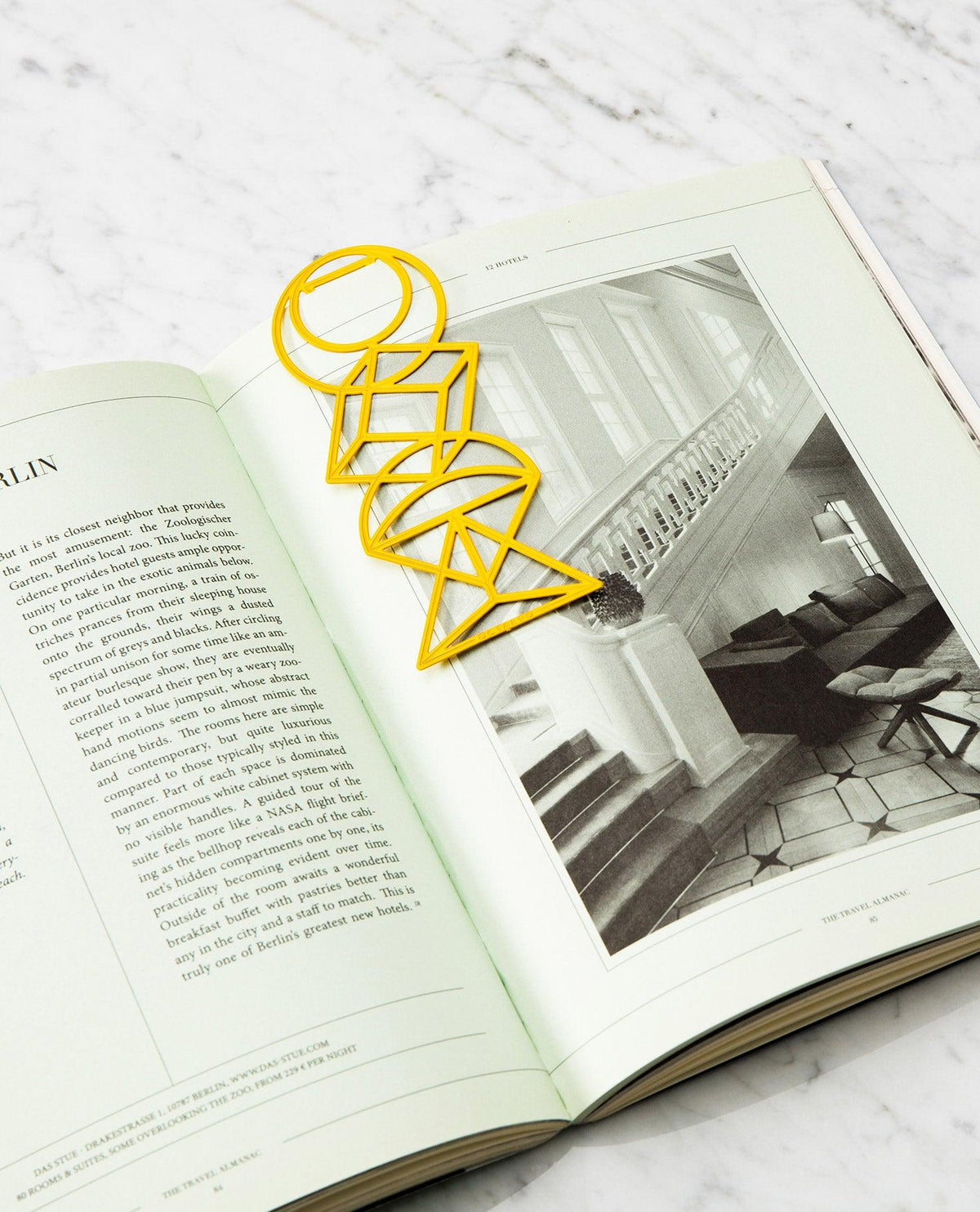 Yellow Bookmark Euclid by OCTAEVO on open book with marble background, photo is shown on the right page.