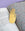 The OCTAEVO Bookmark Hamsa, a brass hand symbolizing blessings, rests on a colorful book with a purple background.