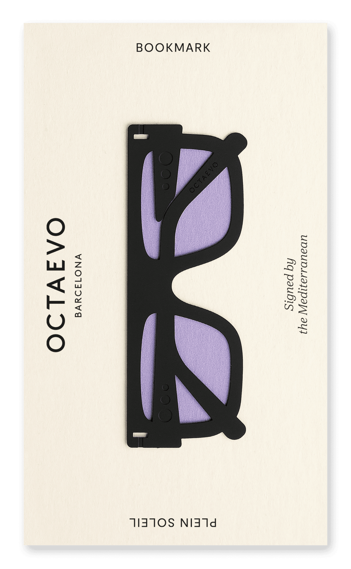 A black Bookmark Plein Soleil by OCTAEVO, shaped like sunglasses with purple lenses on a cream card.