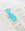 The light blue OCTAEVO Bookmark Sirena rests on an open book against a marble background.