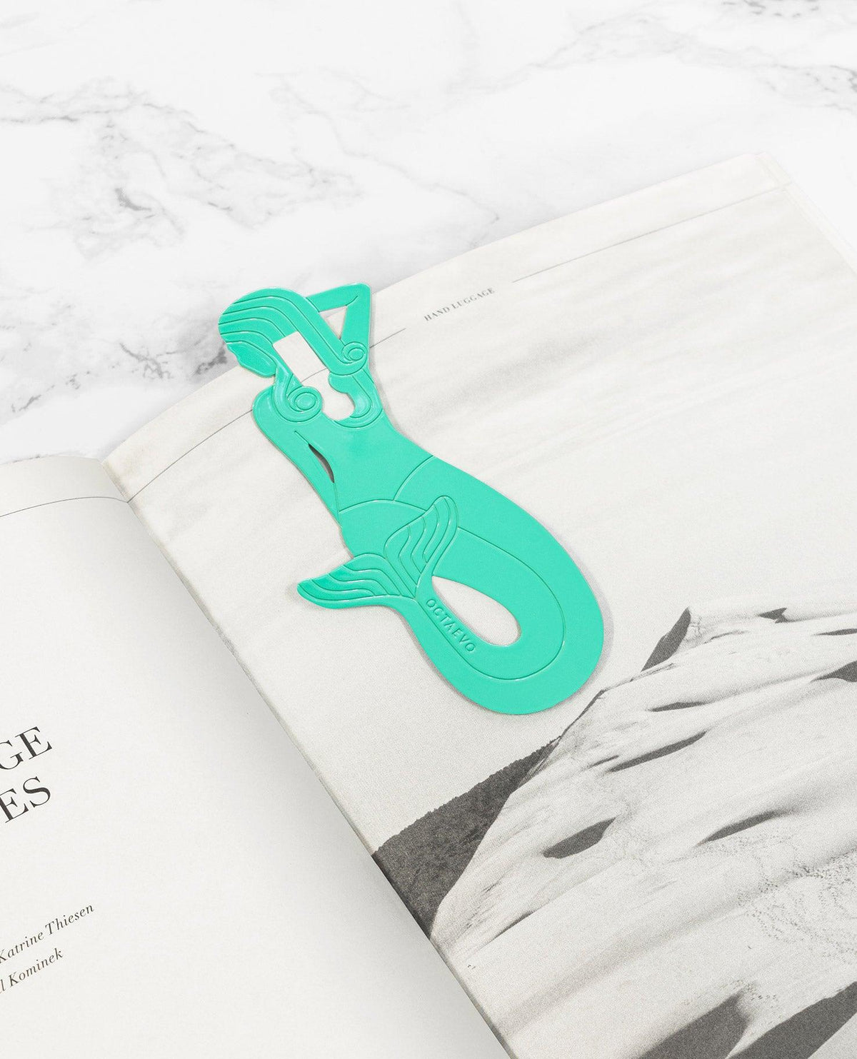 The Bookmark Sirena by OCTAEVO, in mint, clips onto the corner of your book for a stylish touch.