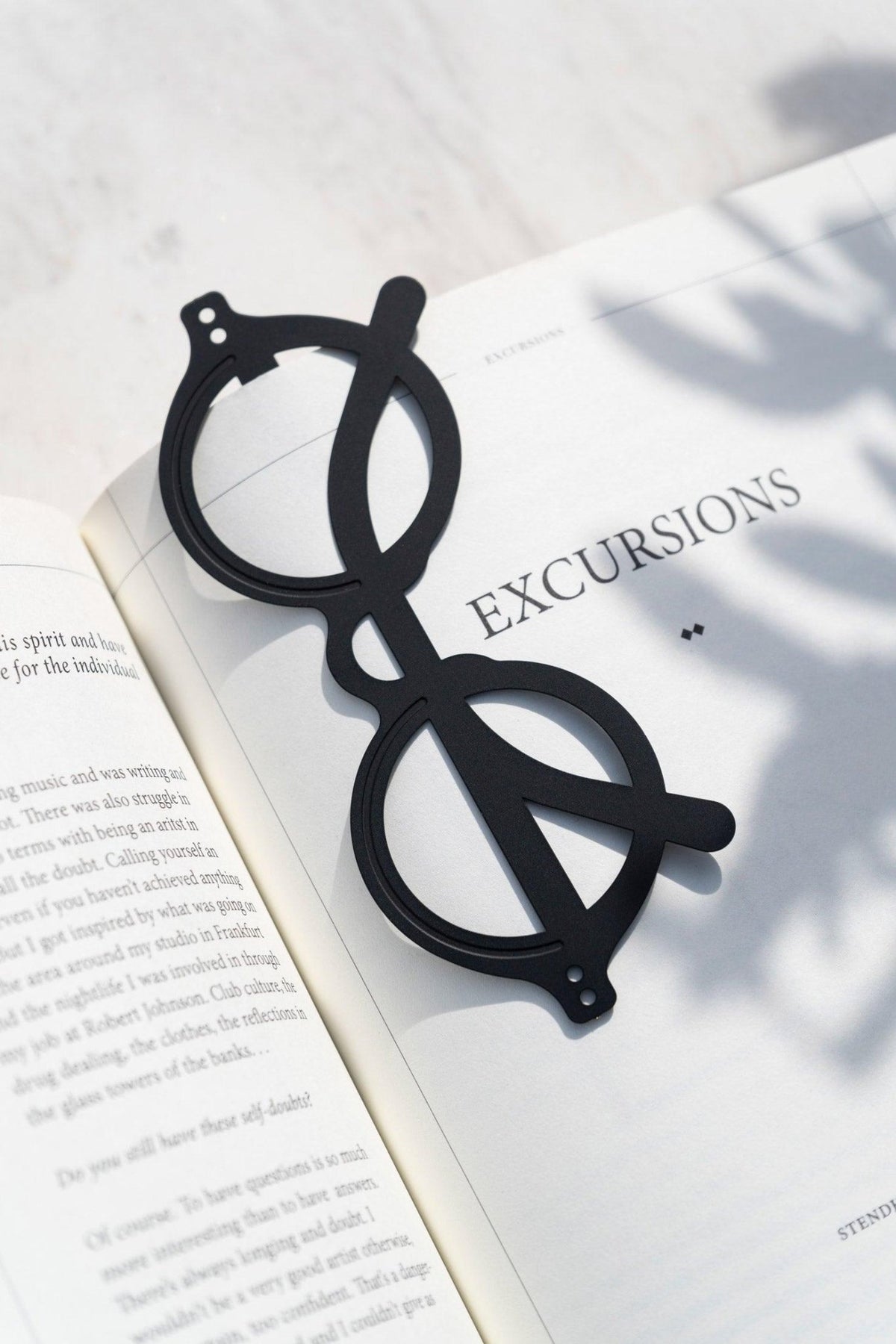 Black Octaevo Bookmark The Voyage on an open book—perfect for Mediterranean daydreams.