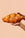 Two hands holding Octaevo’s Braided Bread Candle against a plain beige background.